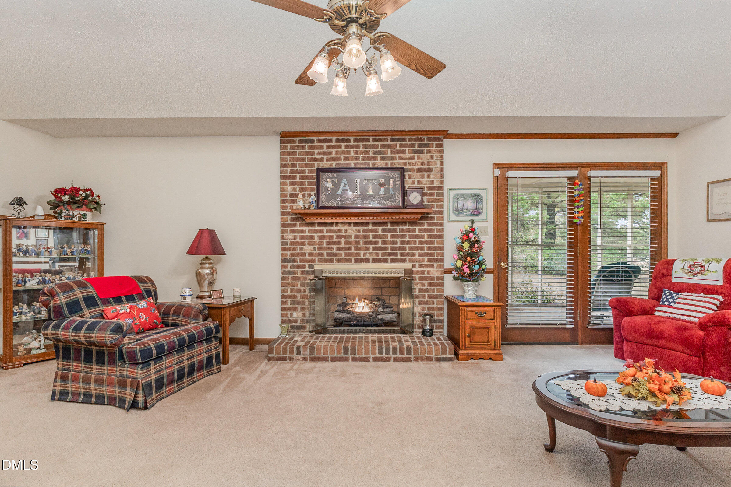 390 Sandy Ridge Road Dunn, NC 28334 - Photo 12 of 45 a living room with furniture a fireplace and a chandelier