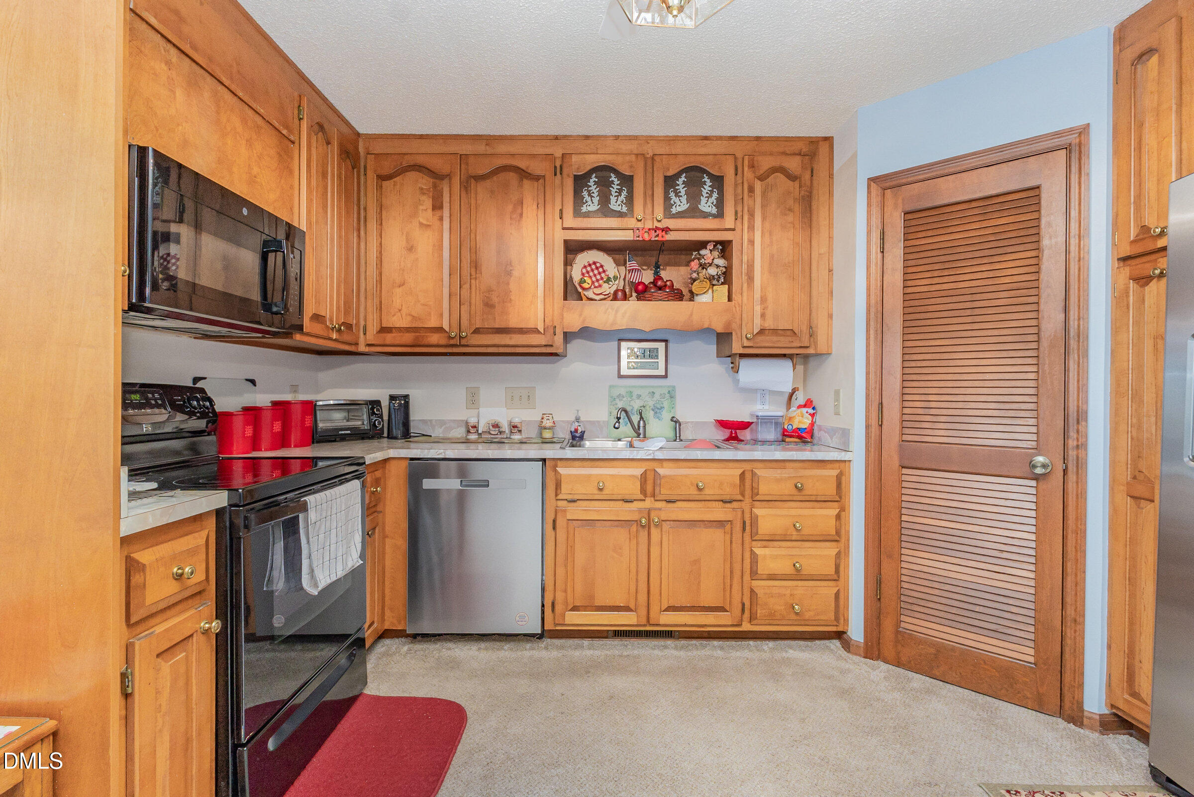 390 Sandy Ridge Road Dunn, NC 28334 - Photo 15 of 45 a kitchen with stainless steel appliances granite countertop a refrigerator and microwave