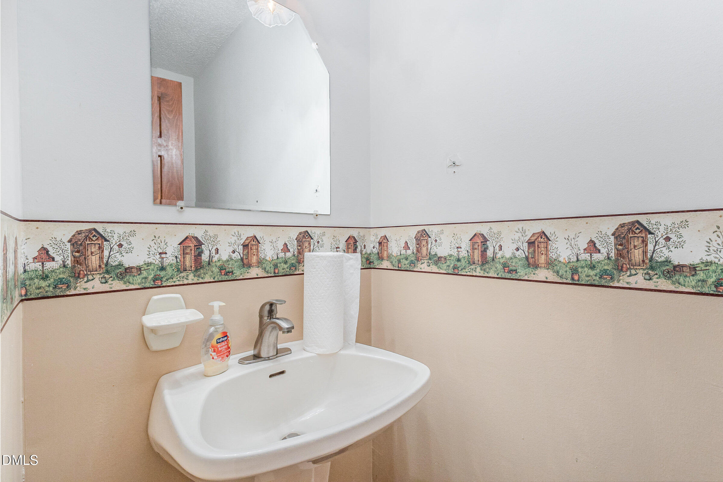 390 Sandy Ridge Road Dunn, NC 28334 - Photo 17 of 45 a bathroom with a sink and a mirror