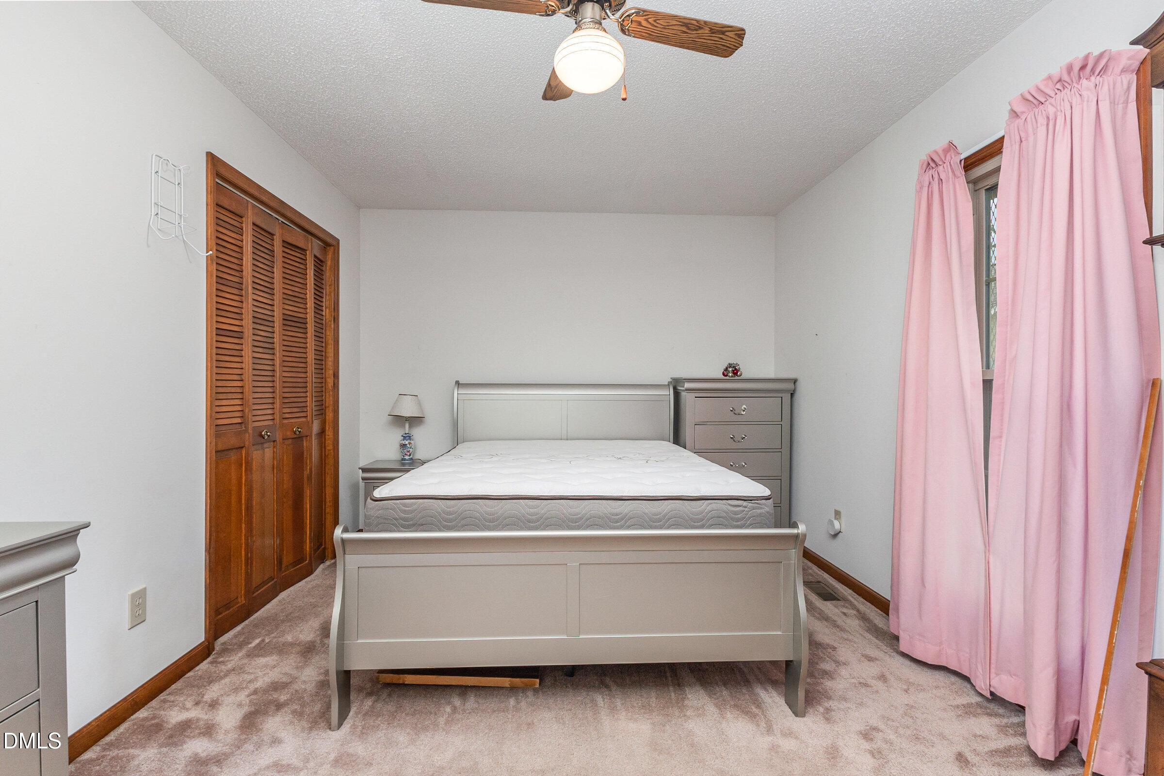 390 Sandy Ridge Road Dunn, NC 28334 - Photo 25 of 45 a bedroom with a bed and a window