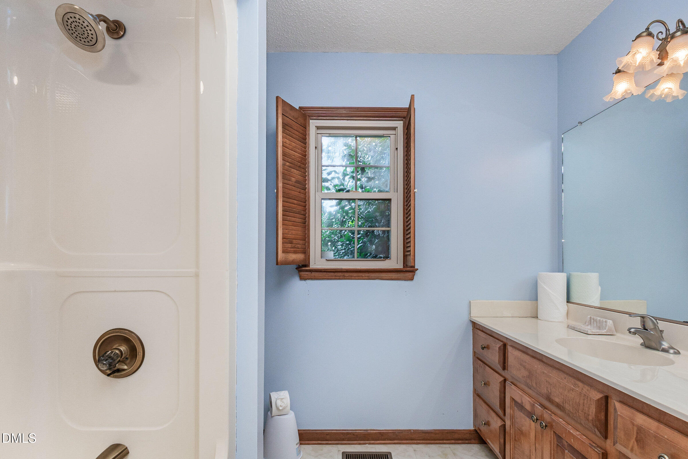 390 Sandy Ridge Road Dunn, NC 28334 - Photo 26 of 45 a bathroom with a sink and a window