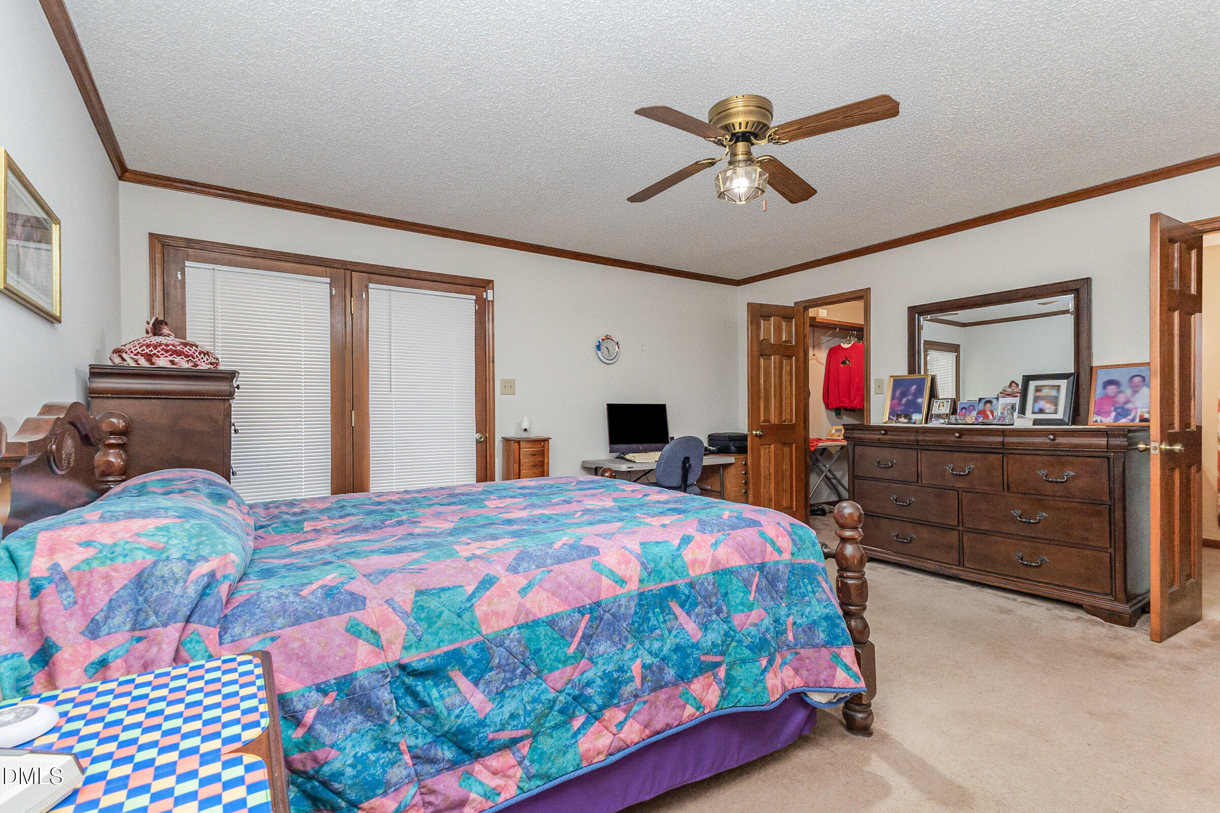 390 Sandy Ridge Road Dunn, NC 28334 - Photo 28 of 45 a bedroom that has a bed and a chandelier