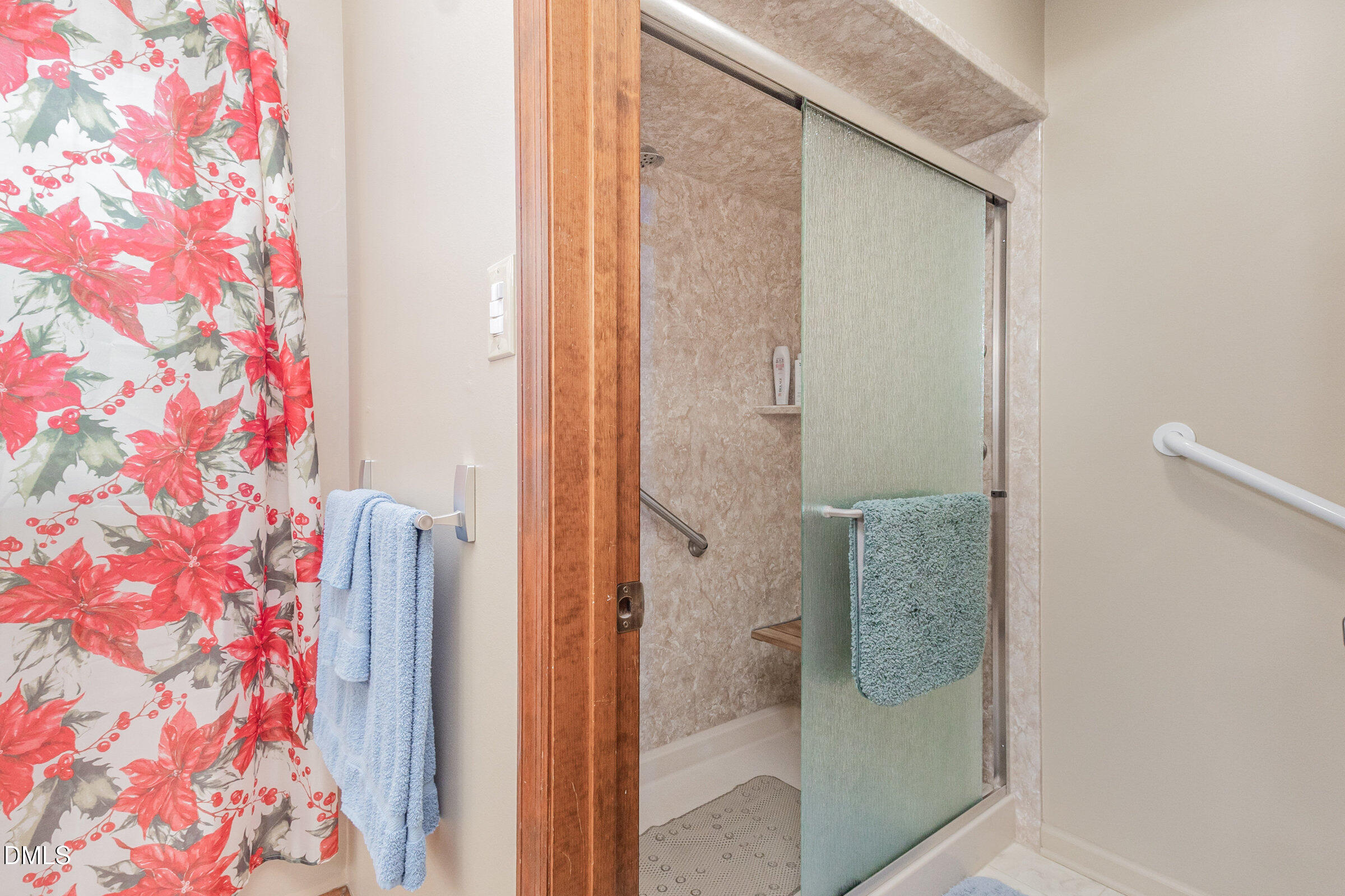 390 Sandy Ridge Road Dunn, NC 28334 - Photo 32 of 45 a bathroom with a glass shower door