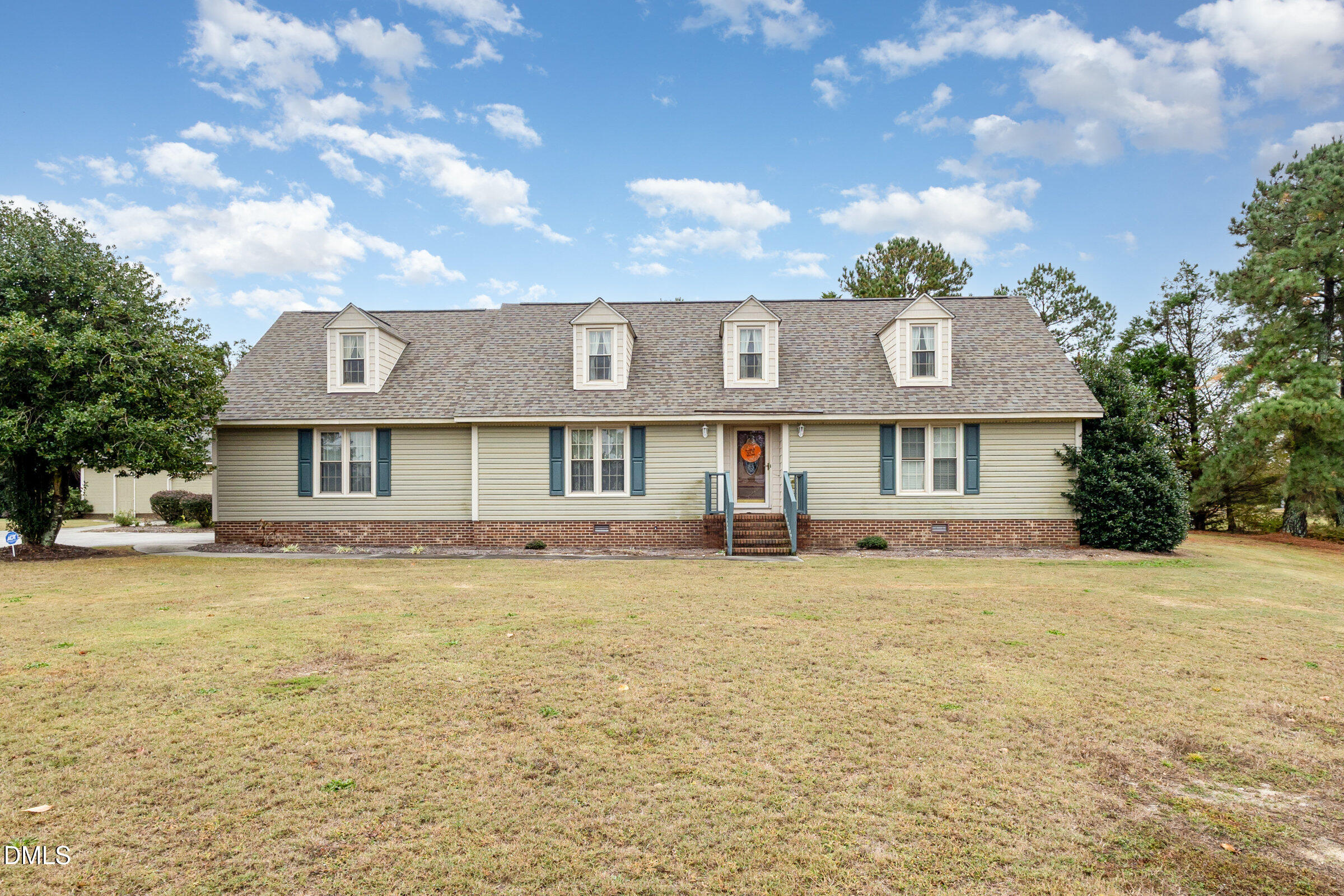 390 Sandy Ridge Road Dunn, NC 28334 - Photo 7 of 45 a front view of a house with a yard