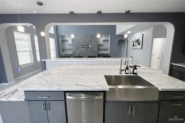 a bathroom with a granite countertop sink a large mirror and vanity