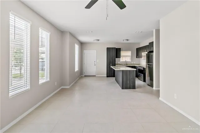 a kitchen with stainless steel appliances a stove top oven a sink a window and stainless steel appliances