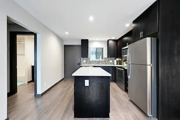 a kitchen with stainless steel appliances a sink stove and refrigerator