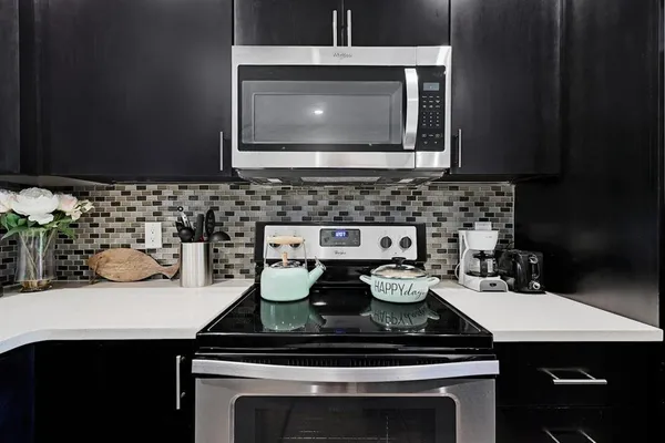 a kitchen with kitchen island a sink counter top space stainless steel appliances and a center island