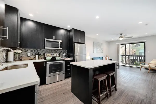 a kitchen with stainless steel appliances a refrigerator and a sink