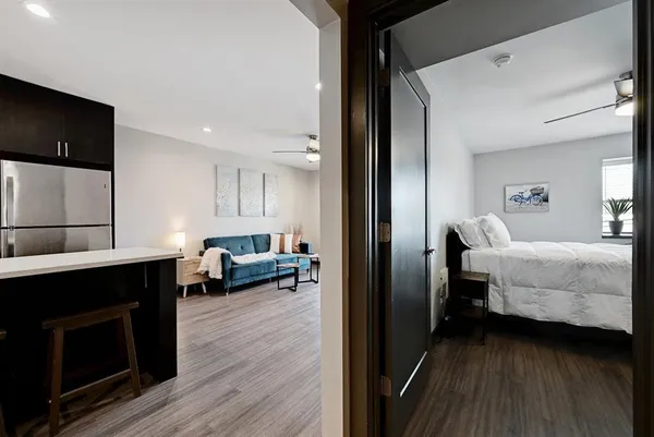 a bedroom with a bed and wooden floor