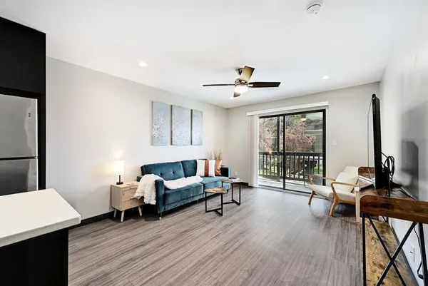 a living room with furniture and wooden floor