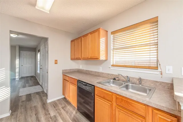 a kitchen with granite countertop a sink and a window