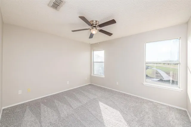a view of room with window and ceiling fan