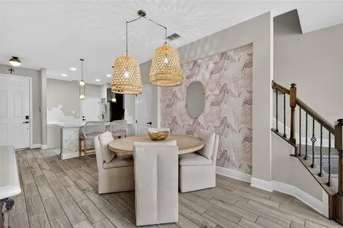 a view of a dining room and hall with wooden floor