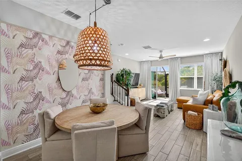 a living room with furniture and a potted plant