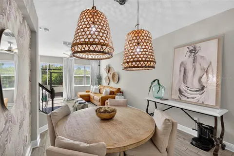 a dining room with furniture a rug and a window