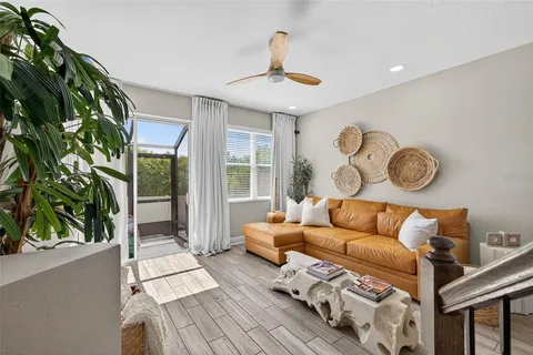 a living room with patio a couch and a potted plant
