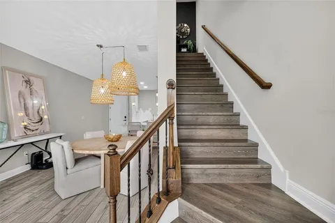 a view of entryway and hall with wooden floor