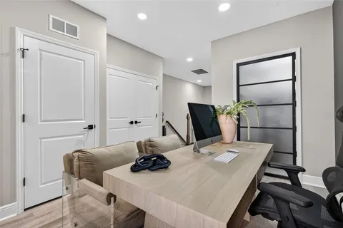 a living room with furniture and wooden floor