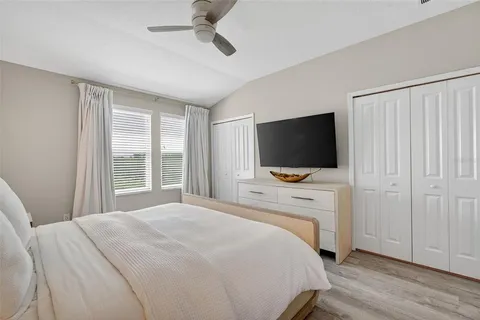 a bedroom with a flat screen television and a bed