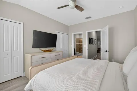 a bathroom with a tub shower sink and mirror