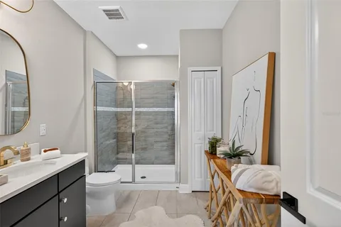 a bathroom with a sink vanity granite and a mirror