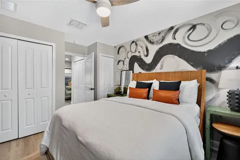 a bedroom with a bed and a flat screen tv