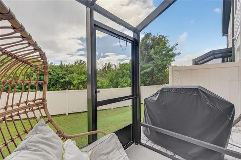 a view of a house with a yard and potted plants