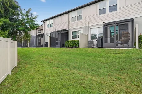 a view of a house with a yard and sitting area