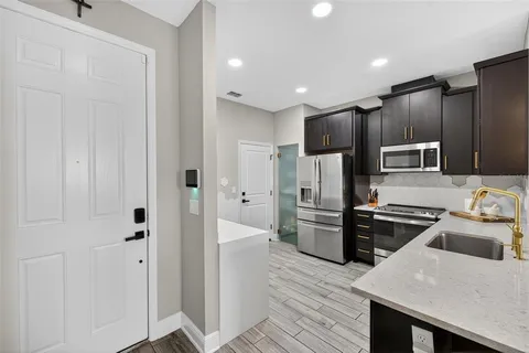a kitchen with a refrigerator stove and sink