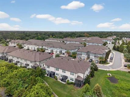 an aerial view of multiple houses with yard
