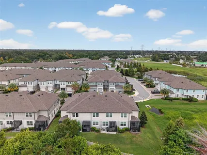 an aerial view of a house with outdoor space and swimming pool