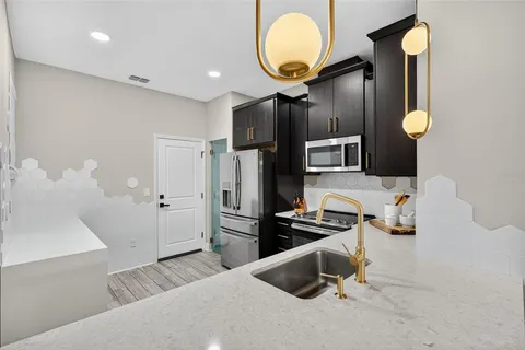 a kitchen with refrigerator and microwave