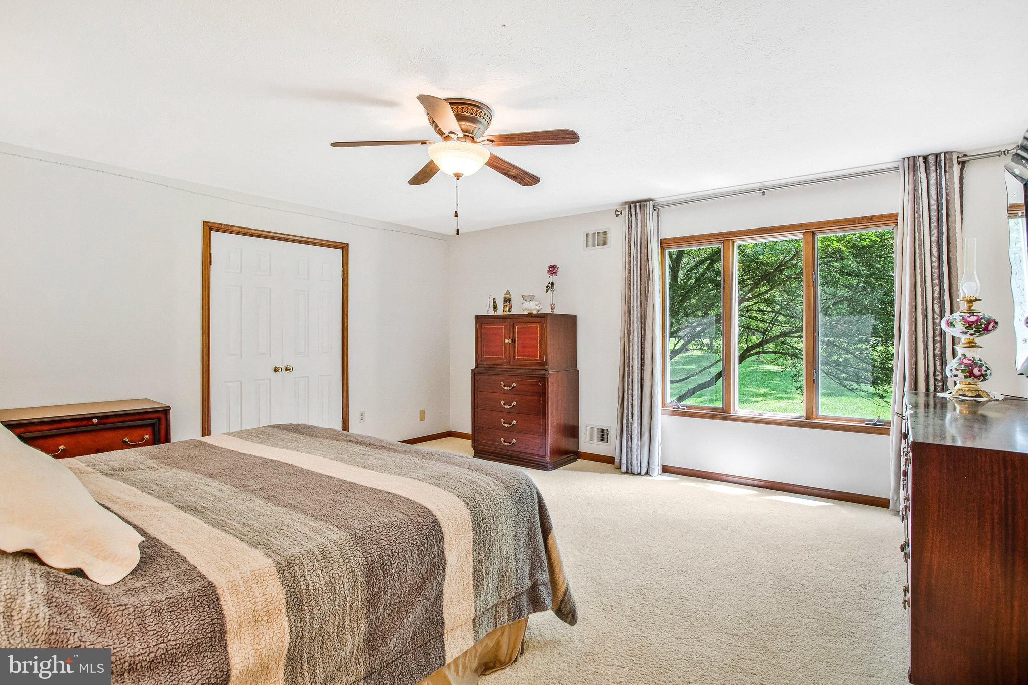 1021 Carson Drive Huntingtown, MD 20639 - Photo 16 of 33 a bedroom with a large bed and a large window