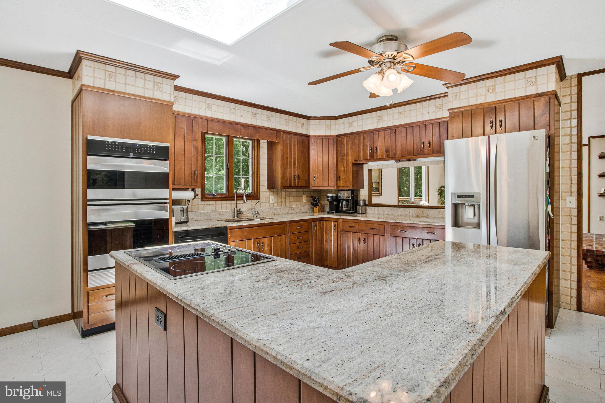 1021 Carson Drive Huntingtown, MD 20639 - Photo 2 of 33 a kitchen with stainless steel appliances granite countertop a sink a stove and a refrigerator