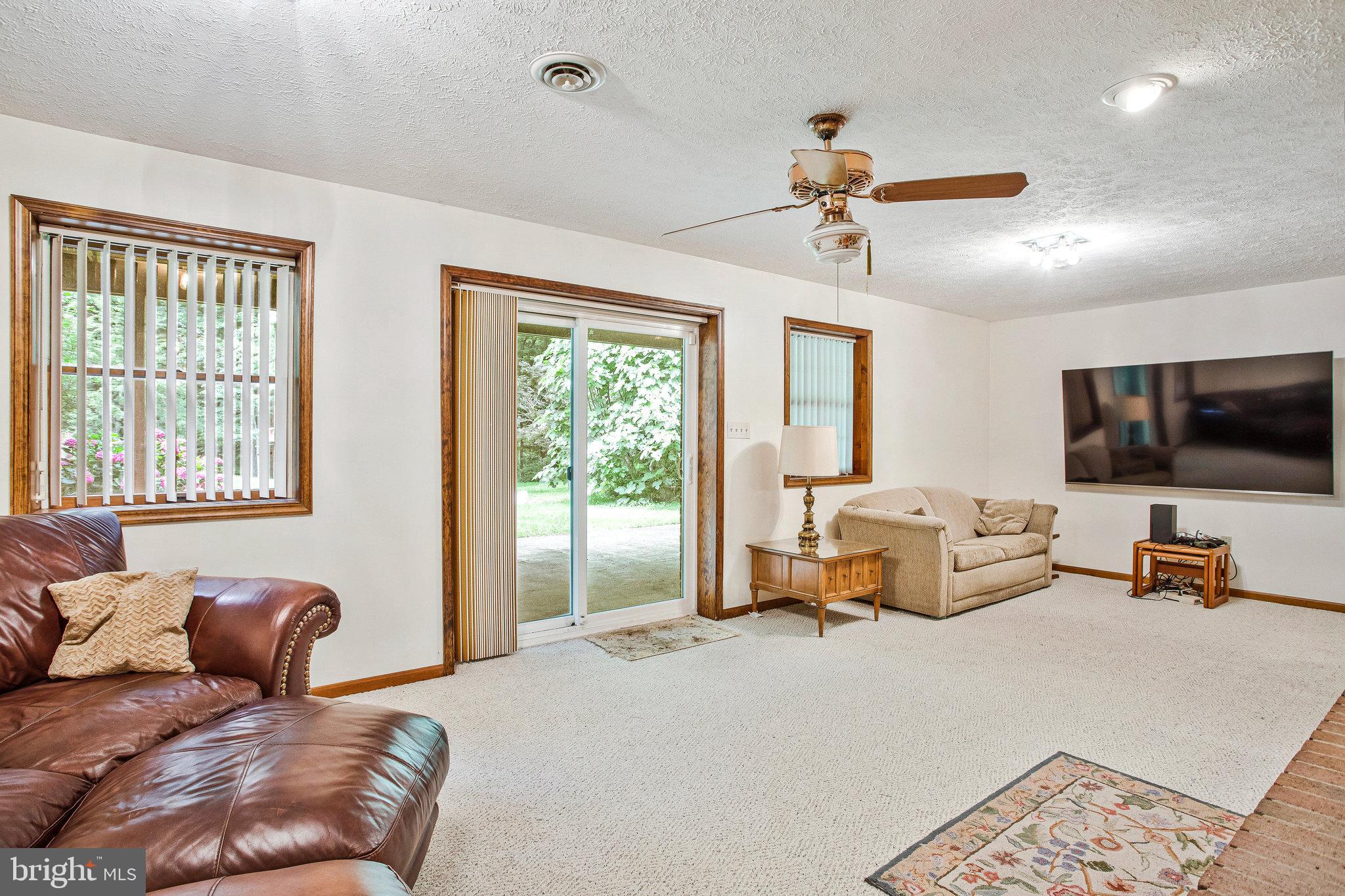 1021 Carson Drive Huntingtown, MD 20639 - Photo 22 of 33 a living room with furniture and a flat screen tv
