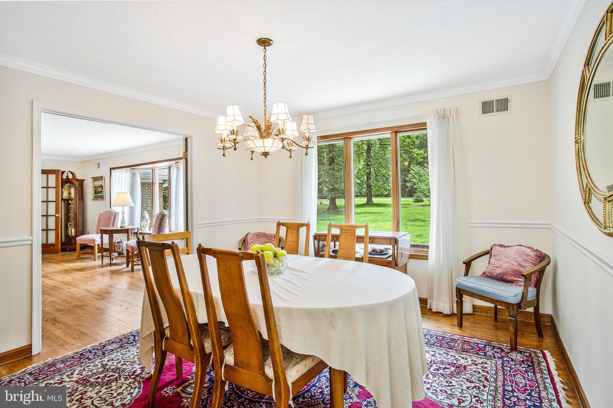 1021 Carson Drive Huntingtown, MD 20639 - Photo 3 of 33 a dining room with furniture a chandelier and wooden floor