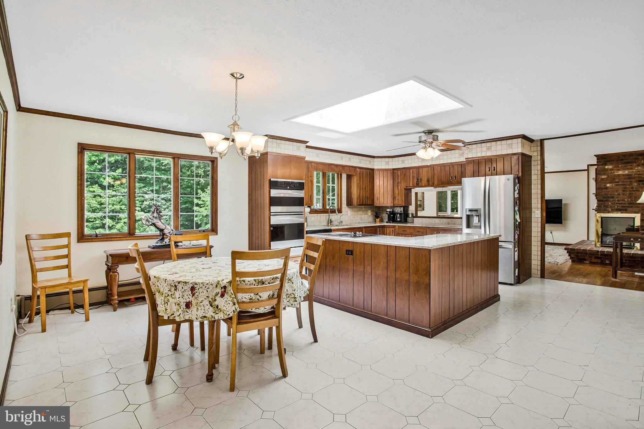 1021 Carson Drive Huntingtown, MD 20639 - Photo 10 of 33 a dining area with furniture a chandelier and window