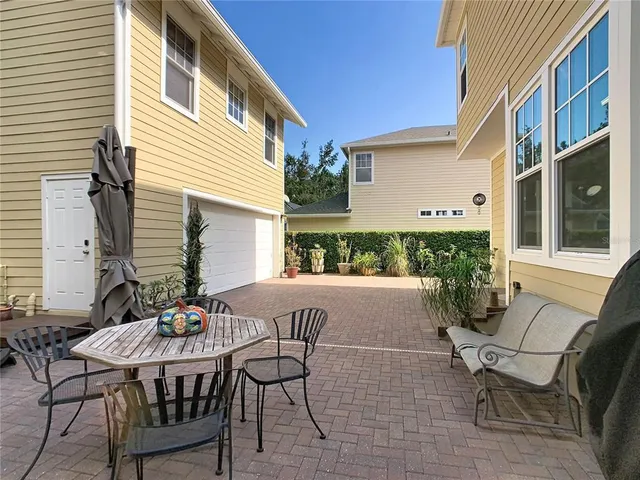 a living room with furniture and a view of kitchen