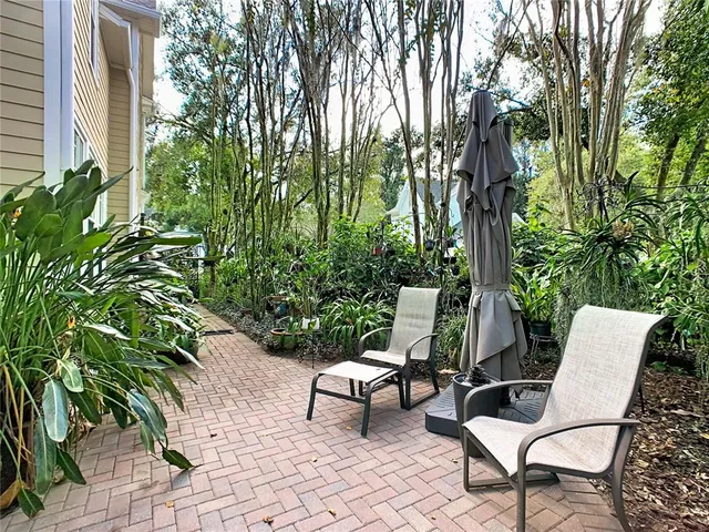 a kitchen with stainless steel appliances granite countertop wooden cabinets a stove a sink a dining table and chairs