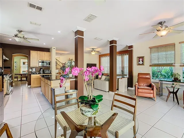a living room with furniture a dining table and a fireplace