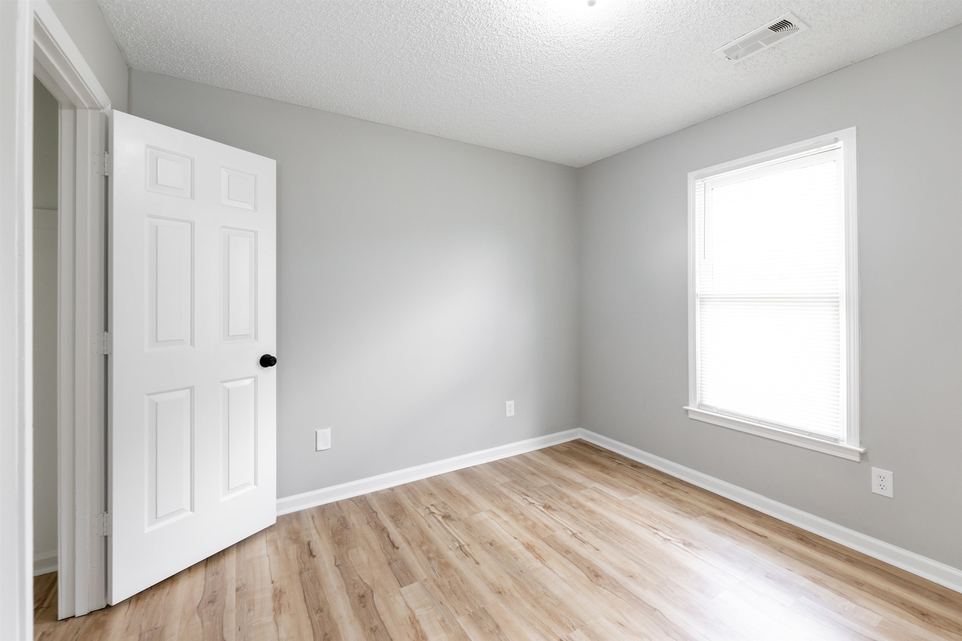 7421 Richmond Road Memphis, TN 38125 - Photo 16 of 39 Room with wood-finish flooring, light gray walls, and white trim