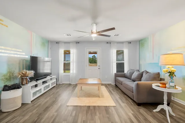 a living room with furniture and a flat screen tv