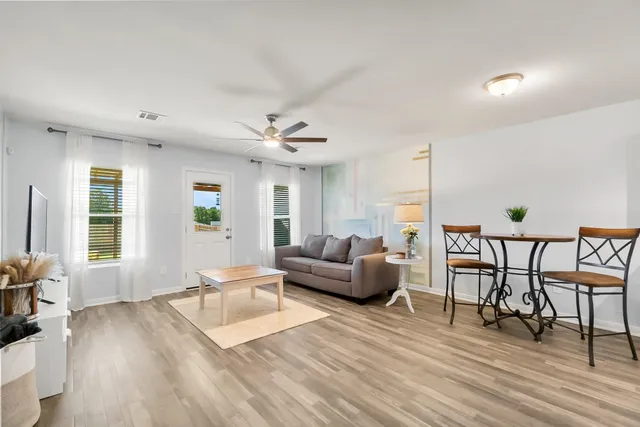 a bathroom with a granite countertop sink a toilet and a mirror