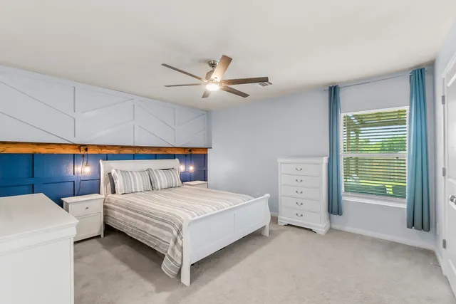 a bedroom with furniture and a chandelier