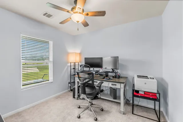 a view of a backyard with sitting area