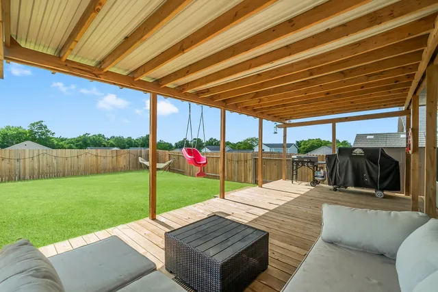 a view of a backyard with sitting area