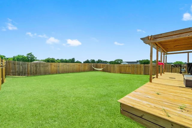 a view of an house with backyard space and balcony