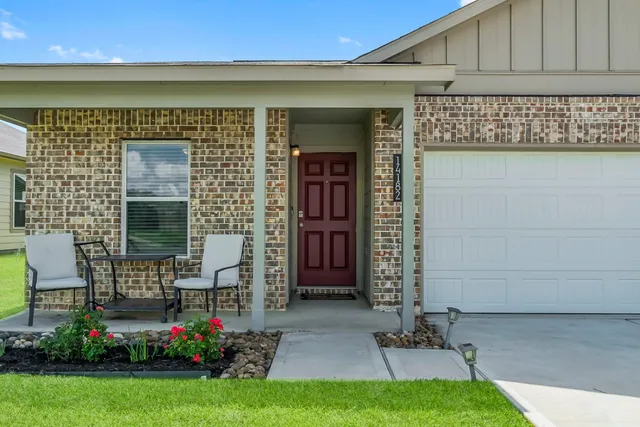 a front view of a house with a garden
