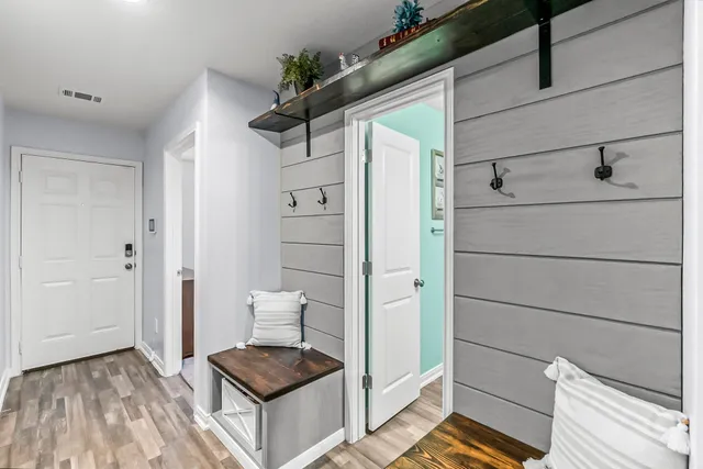 a living room with dining table and wooden floor